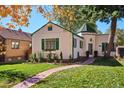 Charming home with a lush front yard, brick walkway at 1275 Birch St, Denver, CO 80220