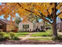 Charming home with a lush front yard, brick walkway with fall foliage in the autumn at 1275 Birch St, Denver, CO 80220