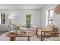 Bright living room with modern decor, neutral color palette, and large windows for natural light at 4450 S Fox St, Englewood, CO 80110