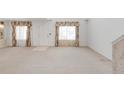 Bright and airy living room featuring neutral carpet and natural light at 1283 W 112Th Ave # B, Denver, CO 80234