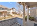 Inviting covered porch offering a glimpse of the front lawn and community green space at 1283 W 112Th Ave # B, Denver, CO 80234