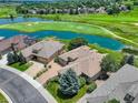 Aerial view of home on golf course, beautiful landscaping, water features, and serene neighborhood at 11208 W Ontario Ave, Littleton, CO 80127