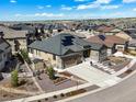 Expansive aerial view of a home with solar panels in a well-developed neighborhood at 8023 Gore Creek Ln, Littleton, CO 80125