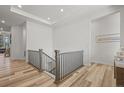 Bright, open hallway with wood floors, neutral decor, and modern railings for a clean, stylish look at 8023 Gore Creek Ln, Littleton, CO 80125