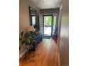 Inviting entryway with hardwood floors, complemented by plants and natural light at 13660 Monroe St, Thornton, CO 80602