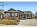 Charming single Gathering home featuring stone accents, a well-kept lawn and a covered porch at 261 Hermosa St, Brighton, CO 80603