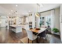 Modern kitchen with stainless steel appliances, white cabinetry, and an island with bar stools at 1104 Brocade Dr, Littleton, CO 80126