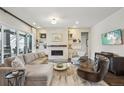 Elegant living room featuring a fireplace, plush seating, and bright, natural light at 1104 Brocade Dr, Littleton, CO 80126