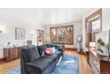 Inviting living room with a comfortable couch, hardwood floors, and natural light from the windows at 1401 N Franklin St # 2, Denver, CO 80218