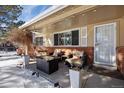 Inviting front porch with cozy seating area, brick accents, and charming lighting at 6834 Hillside Way, Parker, CO 80134