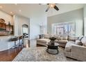 Spacious living room featuring an open floor plan, hardwood floors and large windows at 5181 Delphinium Cir, Brighton, CO 80601