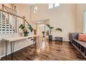 Sunlit foyer with gleaming hardwood floors, an elegant staircase and access to the house at 6302 S Jackson Gap Ct, Aurora, CO 80016