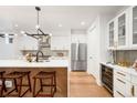 Bright kitchen featuring modern stainless steel appliances, white cabinetry and counter seating at 4227 Mariposa St, Denver, CO 80211