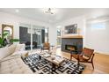 Bright living room with modern fireplace, hardwood floors, and access to outdoor dining area at 4227 Mariposa St, Denver, CO 80211