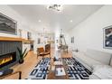 Spacious living room with fireplace and view of kitchen and dining area at 4227 Mariposa St, Denver, CO 80211
