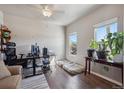 Bright bedroom with hardwood floors, natural light, ceiling fan, and flexible space offers comfort and functionality at 2431 Nicholson St, Berthoud, CO 80513