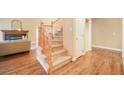 Inviting entryway with hardwood floors, a staircase with wood banister, and neutral walls creating a warm atmosphere at 10 Long Bow Cir, Monument, CO 80132