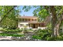 Beautiful home exterior with manicured lawn and flowering trees under a bright sky at 395 N Franklin St, Denver, CO 80218