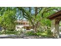 Charming home exterior with lush landscaping, mature trees, and a red-tiled roof at 395 N Franklin St, Denver, CO 80218