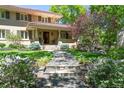 Inviting home facade featuring stone steps, lush garden beds, and a charming covered entrance at 395 N Franklin St, Denver, CO 80218