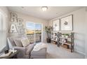 Comfortable sitting area with shelving, reading chair, and outdoor views at 13518 E 103Rd Pl, Commerce City, CO 80022