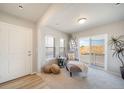 Inviting sitting area with chair, side table, and sliding glass doors to balcony at 13518 E 103Rd Pl, Commerce City, CO 80022