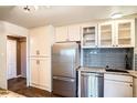 Kitchen features stainless steel appliances, stone counters, modern cabinetry, and tile backsplash at 3131 E Alameda Ave # 1503, Denver, CO 80209