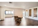 Spacious living room featuring hardwood floors, ample natural light, and a brick accent wall at 3131 E Alameda Ave # 1503, Denver, CO 80209