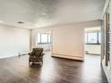 Open living room with hardwood floors and lots of light from the large windows at 3131 E Alameda Ave # 1503, Denver, CO 80209