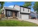Exterior of home with a garage, lawn, steps, and a brick facade at 11407 W 103Rd Ave, Broomfield, CO 80021