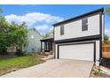 Two-story home with a garage, lawn, and a nearby home at 11407 W 103Rd Ave, Broomfield, CO 80021