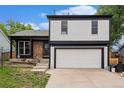 Two-story home featuring a garage and front yard at 11407 W 103Rd Ave, Broomfield, CO 80021