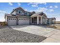 Stunning home exterior featuring a three-car garage, a modern design, and a large driveway at 14378 Heritage Dr, Mead, CO 80504