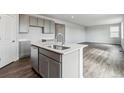 Open-concept kitchen with island, stainless steel dishwasher, and sleek gray cabinets at 14378 Heritage Dr, Mead, CO 80504