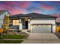 New single-story home with gray siding, stone accents and a two-car garage at 17305 E 91St Pl, Commerce City, CO 80022