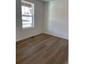 Bright bedroom with laminate flooring and a window offering natural light at 21965 E 39Th Ave, Aurora, CO 80019