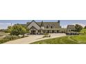 Exterior view of golf clubhouse near well-manicured green and rows of golf carts at 21965 E 39Th Ave, Aurora, CO 80019