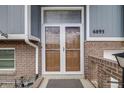 Close-up of the front entry featuring a double-door and brick facade at 6893 S High St, Centennial, CO 80122
