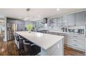 Spacious kitchen featuring a large island, stainless steel appliances, and updated cabinets at 6893 S High St, Centennial, CO 80122