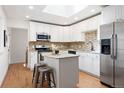 Modern kitchen with stainless steel appliances, granite countertops, and ample cabinet space at 5698 E Greenwood Pl, Denver, CO 80222