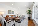 Bright living room features hardwood floors, large windows and stylish furniture at 5698 E Greenwood Pl, Denver, CO 80222