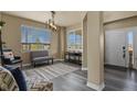 Bright entryway features hardwood floors, large windows, and neutral wall color offering a welcoming space at 5285 La Quinta Cir, Elizabeth, CO 80107
