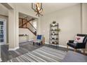 Inviting living room with hardwood floors, modern lighting, and a staircase at 5285 La Quinta Cir, Elizabeth, CO 80107