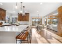Open-concept kitchen with a large island, bar seating, and seamless flow to the dining and living areas at 35 Brookhaven Ln, Littleton, CO 80123