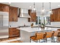 Modern kitchen featuring a spacious island, stainless steel appliances, and stylish pendant lighting at 35 Brookhaven Ln, Littleton, CO 80123