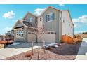 Side view of this charming two-story home with a two-car garage and well-maintained lawn at 6361 Kenzie Cir, Castle Pines, CO 80108