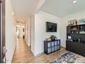 Bright and spacious entryway with hardwood floors and views to the dining area at 2300 Mountain Sky Dr, Fort Lupton, CO 80621