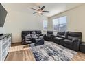 Spacious living room with large windows and a ceiling fan at 2300 Mountain Sky Dr, Fort Lupton, CO 80621