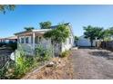 Charming one-story home with a detached garage and a fenced yard at 252 S Owens St, Byers, CO 80103