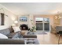 Cozy living room with fireplace, gray couch, and sliding glass door to the outside at 1350 Josephine St # 307, Denver, CO 80206